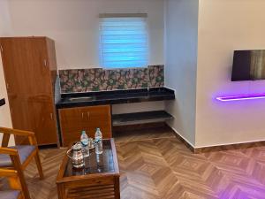 a living room with a table and a tv at Gokarna City Guest House in Gokarna +19 photos