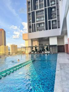 a large swimming pool in front of a building at Chamber Haven KL in Kuala Lumpur