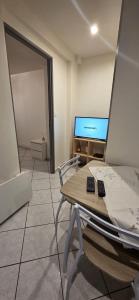 a living room with a table and a tv at Studio 33 m2 a saint Michel de Maurienne in Saint-Michel-de-Maurienne