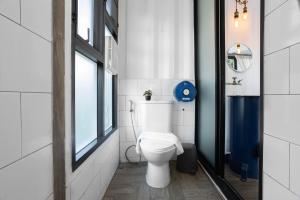 a bathroom with a white toilet and a window at serene hotel in Chiang Mai +19 photos