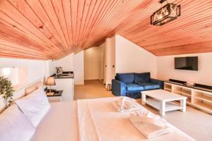 a bedroom with a large bed and a blue couch at Azure Palm Resort in Oludeniz
