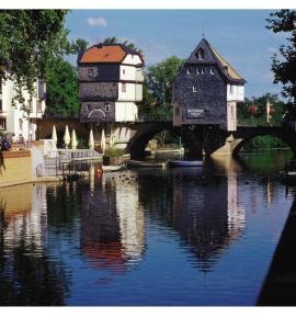 a bridge over a body of water with a building at Little Castle in Bad Kreuznach
