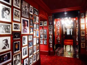a room full of pictures on a wall at Hotel Sacher Wien in Vienna