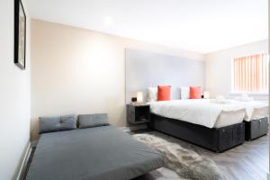 a bedroom with a bed and a couch at Hotel LIV in Birmingham