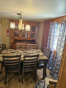 a dining room with a table and chairs at Mem's Place in Bluefield +2 photos
