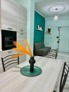 a dining room table with a vase on top of it at A casa di Ro 2 in Nola