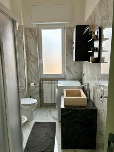 a bathroom with a sink and a toilet and a window at A casa di Ro 2 in Nola +10 photos
