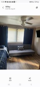 a bedroom with a blue couch in a room at Mem's Place in Bluefield