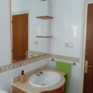 a bathroom with a sink and a mirror at Mar y Sol in Calafell
