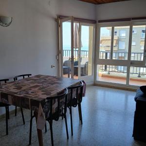 a dining room with a table and a view of the ocean at Mar y Sol in Calafell +9 photos