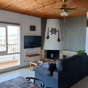 a living room with a couch and a fireplace at Mar y Sol in Calafell