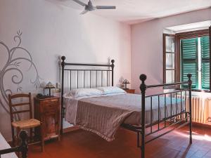 a bedroom with a bed and a ceiling fan at Al Vecchio Convento in Portico di Romagna