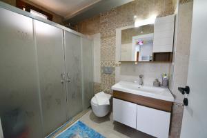 a bathroom with a sink and a shower and a toilet at Gold villa in Fethiye +19 photos
