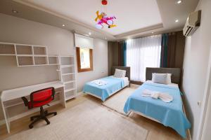 a hospital room with two beds and a desk at Gold villa in Fethiye