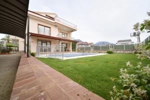 a courtyard of a house with a lawn at Gold villa in Fethiye