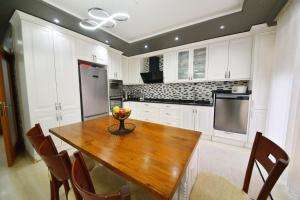 a kitchen with a wooden table with a bowl of fruit on it at Gold villa in Fethiye