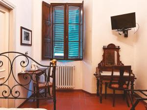 a room with a chair and a table and a window at Al Vecchio Convento in Portico di Romagna
