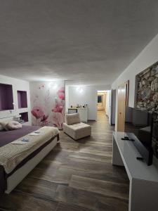 a bedroom with a bed and a living room at B&B Blue Dragonfly in Paesana