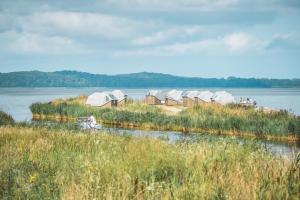 a group of tents on the shore of a lake at Marina Martinshafen - Beach life in Sassnitz +39 photos