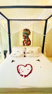 a bed with a heart drawn on it at Villa Rebecca 1 at Paparemo Village in Watamu