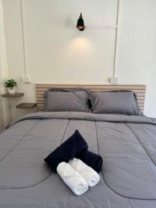 a bed with two towels on top of it at The cozy house in Trang