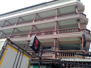 a building with a sign on the side of it at Nana's Apartment in Pattaya
