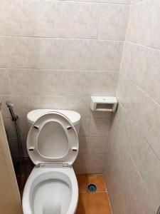 a bathroom with a white toilet in a stall at Nana's Apartment in Pattaya