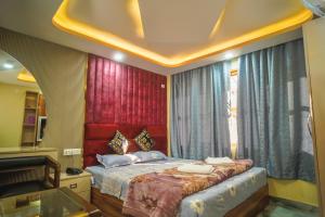 a bedroom with a bed and a window at Hotel Sahil - City Center, LalChowk in Srinagar