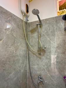 a shower with a hose in a bathroom at TUBURAN Poolside in Sara +78 photos