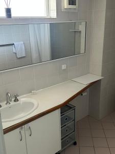 a bathroom with a sink and a mirror at Manduhra Motel Resort in Mandurah +6 photos