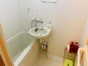 a small bathroom with a sink and a bath tub at HOTEL k&m in Tokyo +18 photos