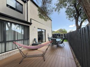 a hammock on a deck in a house at Aalto Retreat 3 - Chic Modern Close to Everything in Rosebud