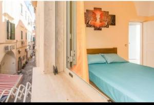 a bedroom with a blue bed in a building at White Sand in Gallipoli