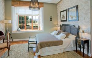 a bedroom with a large bed and a window at Casón de la Marquesa in Las Fraguas +26 photos
