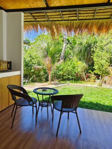a patio with a table and chairs and a view of a yard at Ingtara at Lanta in Ko Lanta