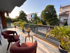 a balcony with two chairs and a table with plants at Hotel Fortune Home Residency Near Spectrum Mall Sector 72 in Noida
