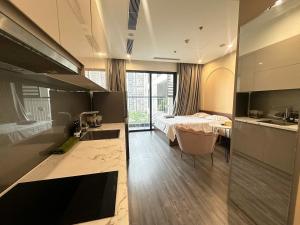 a room with a bed and a kitchen with a sink at R1 Studio Ruby Zenpark in Gia Lâm Pho