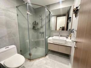 a bathroom with a shower and a toilet and a sink at R1 Studio Ruby Zenpark in Gia Lâm Pho