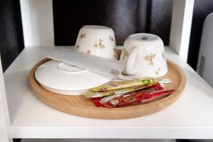 a table with two cups and a plate with food at B&T Hostel in Ban Pa Tung (7) +25 photos