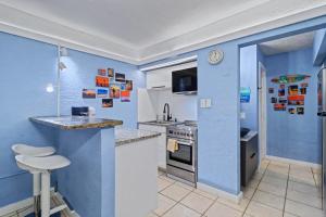 a kitchen with blue walls and a counter top at Pass-A-Grille Beach Retreat Unit 8 in St. Pete Beach