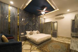 a bedroom with a bed and a ceiling fan at Lumira Queensbury Villa in Udaipur