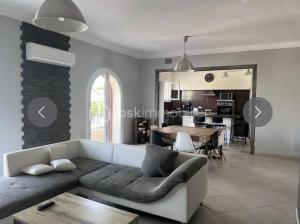 a living room with a couch and a table at Aux Chti Bains in Balaruc-le-Vieux +9 photos