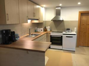 a kitchen with white appliances and a wooden counter top at Ferienhaus Kollmer in Bad Koetzting