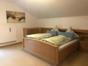 a bedroom with two beds and a painting on the wall at Ferienhaus Kollmer in Bad Koetzting