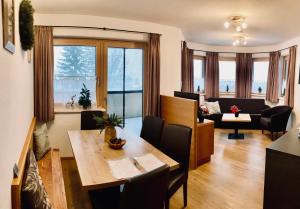 a living room with a table and a couch at Sedlhof Apartment in Grub