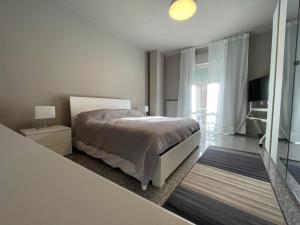 a bedroom with a bed and a large window at Vibo Centro Home in Vibo Valentia