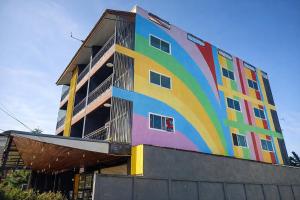 a building with a rainbow painted on the side of it at B&T Hostel in Ban Pa Tung (7)