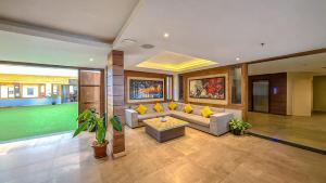 a living room with a couch and a table at Yashshree Sanderling Mall Road in Darjeeling
