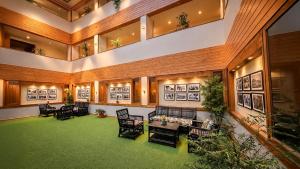 a large room with chairs and a table in it at Yashshree Sanderling Mall Road in Darjeeling +71 photos