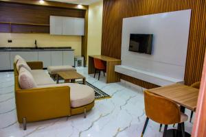 a living room with a couch and a television at Soulmate Hotels and Suites in Mawere